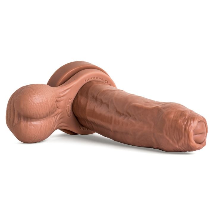 Chode dildo in Natural Tan laying flat at an angle with Remove-O-Balls, showcasing ultra-thick girth, realistic uncut head, and veined shaft."