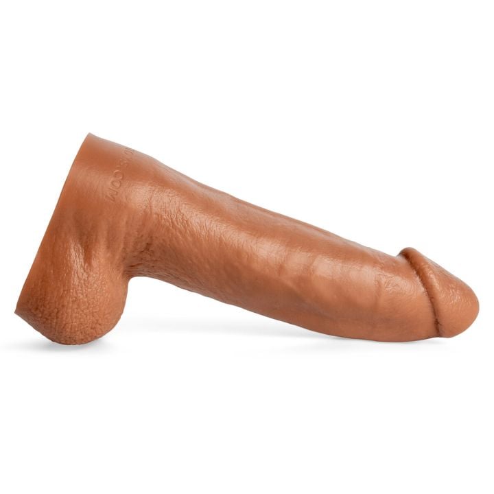 Clip Clop handcrafted silicone dildo in Natural Tan laying horizontally, side profile highlighting veined shaft and contoured ridges for lifelike texture