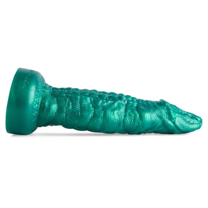 Cockadile fantasy dildo by Mr. Hankey’s Toys laying flat, side view highlighting crocodile-inspired ridges, textured shaft, and smooth underbelly.