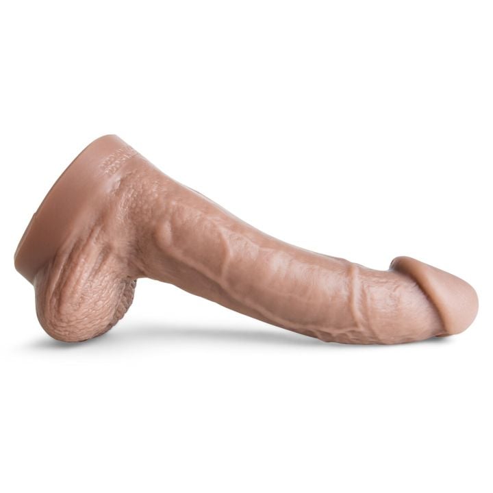 Side profile of the Cyrus King Dildo in Natural Tan, showcasing the thick, curved shaft, lifelike veining, and bulbous head sculpted for deep stimulation and advanced size play.