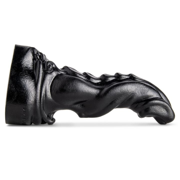 Scimitar Fantasy Dildo by Mr. Hankey’s Toys laying flat, showcasing its scaled back texture and curved design.