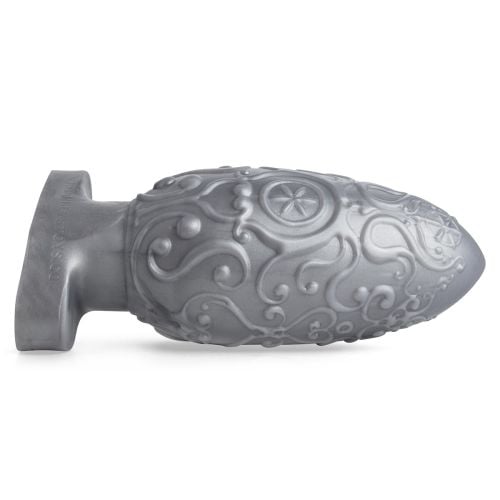 Assberge Egg Plug, Butt Plug, in Silver Metallic laying on its side with filigree detail