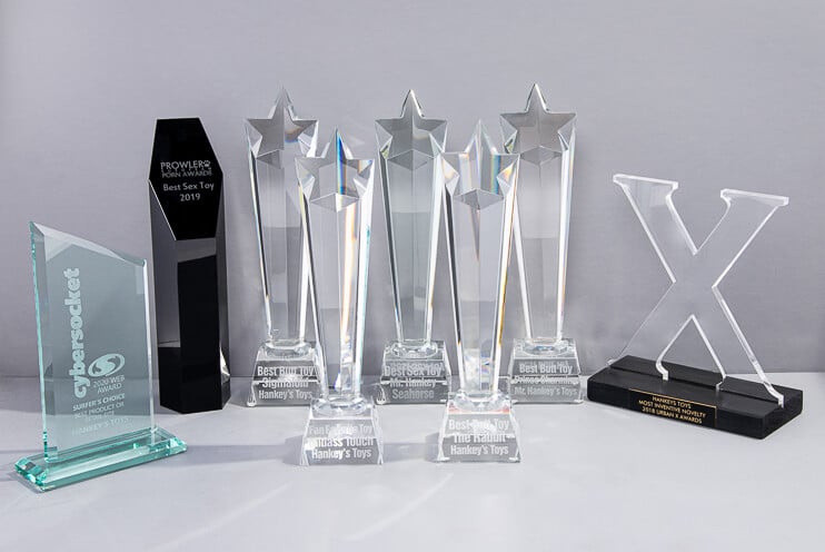 Display of Mr. Hankey&rsquo;s Toys industry awards - including AVN, XBIZ, AltStar, Cybersocket, Urban X, and Prowler Awards - recognizing handcrafted silicone sex toys for quality and design.
