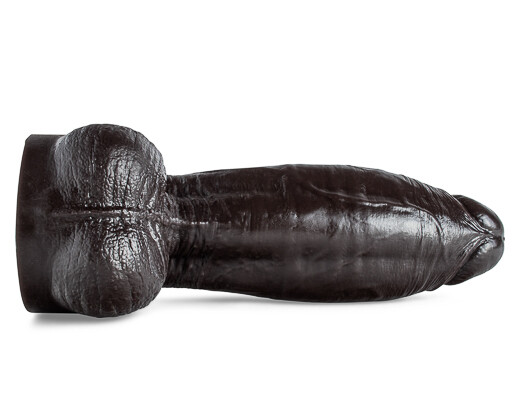 Dramatic under view of Atlas dildo in bold lighting, highlighting its lifelike texture, large size, nice balls, and BDSM-friendly design.