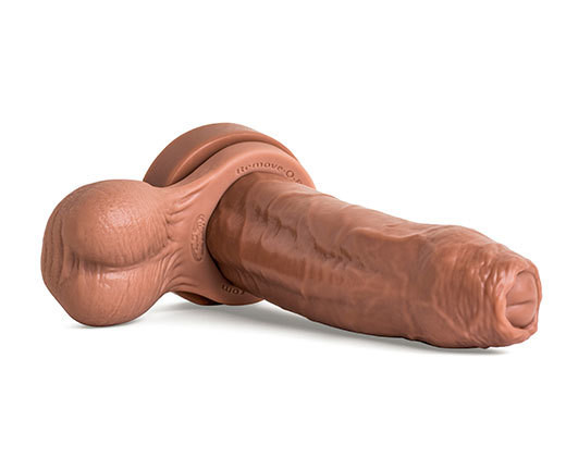 Chode dildo in Natural Tan laying flat at an angle with Remove-O-Balls, showcasing ultra-thick girth, realistic uncut head, and veined shaft."
