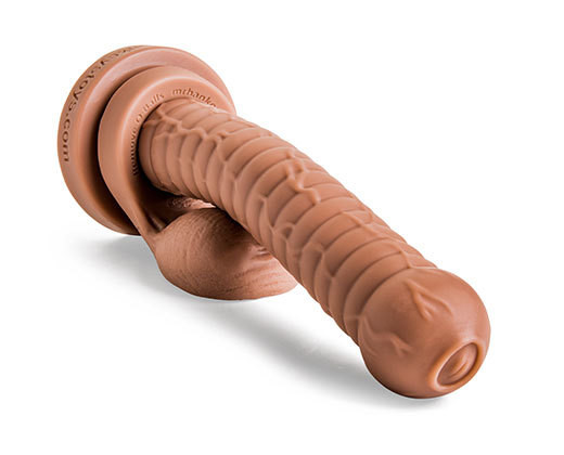 Cyclops fantasy dildo laying flat, close-up view of sculpted head and textured veins with attached Remove-O-Balls in Natural Tan silicone.