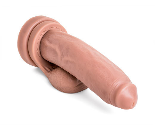 Angled view of the Cruiser dildo highlighting its circumcised head and handcrafted vein detail, crafted for smooth entry and bold penetration, pictured with Remove-o-Balls that are sold seperately.