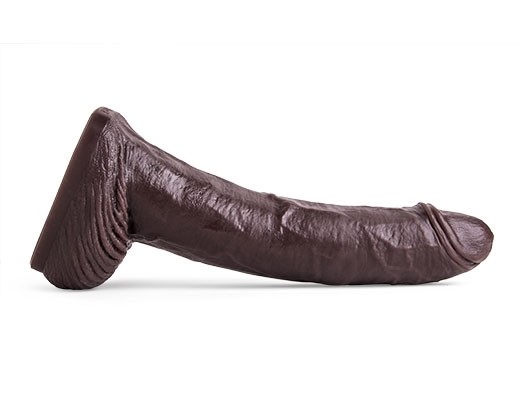 Full side profile of the Cutler X Dildo, showcasing its lifecast contours, thick shaft, and sculpted head crafted from body-safe platinum-cured silicone.