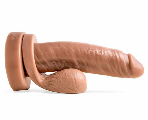 Big Daddy fantasy dildo in Natural Tan laying horizontally, side profile showing realistic bulging veins and optional Remove-O-Balls at base.