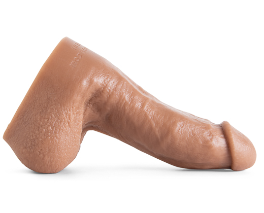 Side angle of the Aaron Klein dildo highlighting lifelike curvature and detailed anatomical structure in Natural Tan silicone.