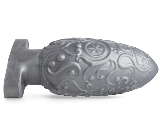 Assberge Egg Plug, Butt Plug, in Silver Metallic laying on its side with filigree detail
