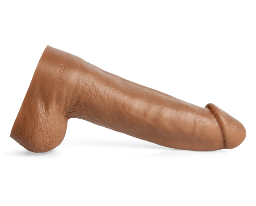 Clip Clop handcrafted silicone dildo in Natural Tan laying horizontally, side profile highlighting veined shaft and contoured ridges for lifelike texture