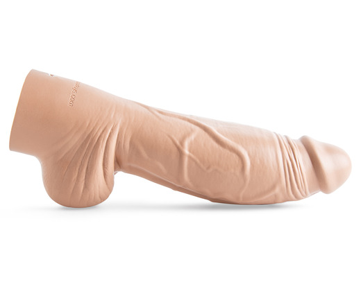Mr. Hankey's Toys' light skin toned realistic End Zone dildo placed horizontally with its side profile facing the viewer.