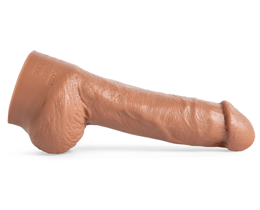 Marco Napoli dildo by Mr. Hankey’s Toys laying flat, side view showcasing lifecast veins, sculpted shaft, and realistic head in Natural Tan silicone.
